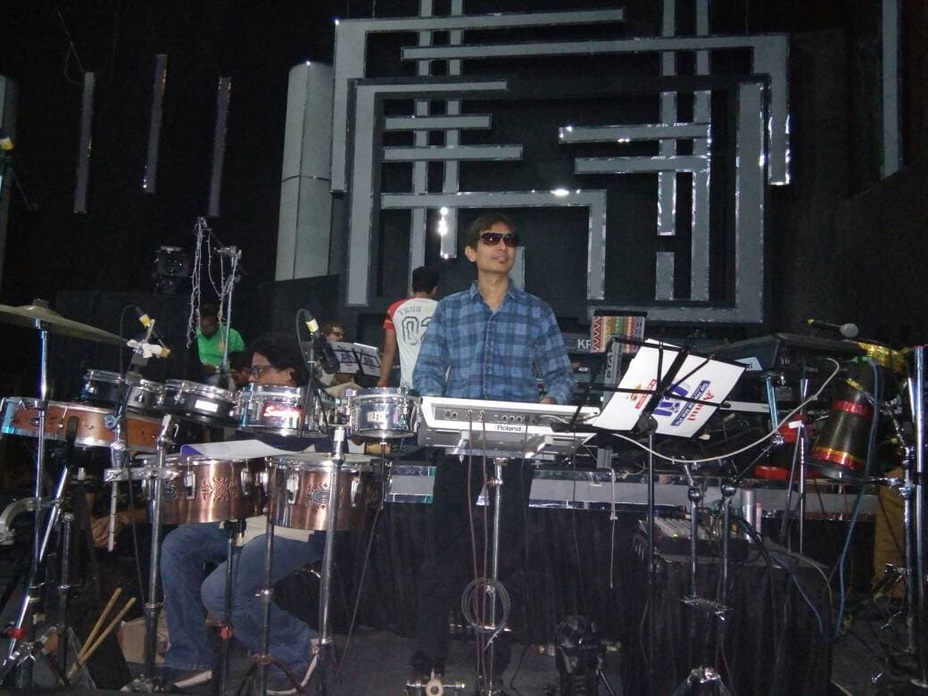 Mrugesh Shukla, professional live musician, performing on keyboard on stage
