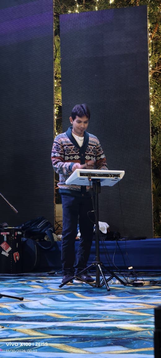 Mrugesh Shukla performing on keyboard on an outdoor stage